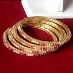 STYLE STATEMENT RUBY AD BANGLES IN GOLDEN POLISH