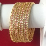 HIGH PROFILE STATEMENT CLASS BANGLE IN RUBY AND WHITE AD WITH GOLDEN POLISH 