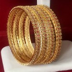 HIGH PROFILE STATEMENT CLASS BANGLE IN RUBY AND WHITE AD WITH GOLDEN POLISH 