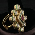 WHITE POLKI IN GOLDEN D SURROUNDING RUBY AND AD SQ RING