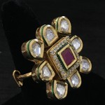WHITE POLKI IN GOLDEN D SURROUNDING RUBY AND AD SQ RING